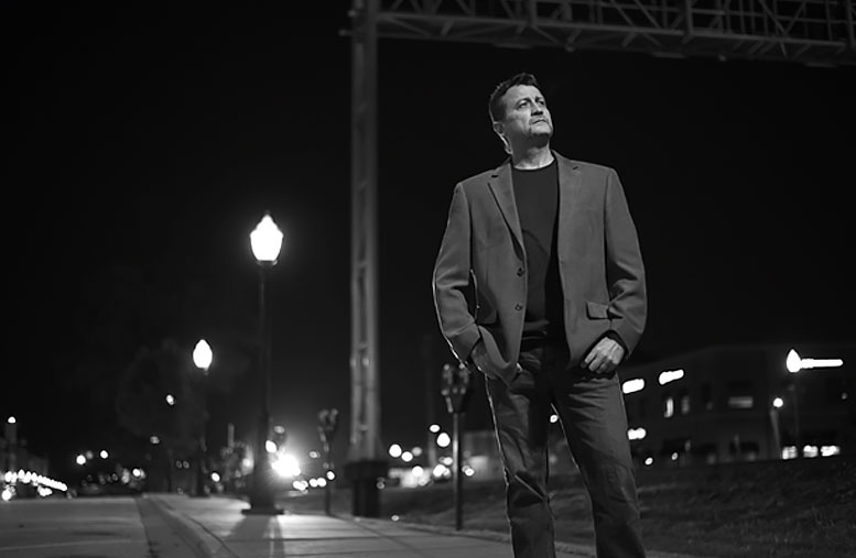 Ken Jackson in front of railroad tracks.