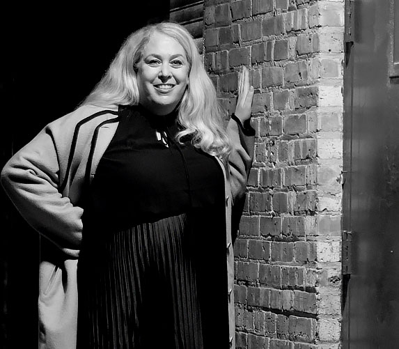 Michelle Crowe standing against brick wall in downtown LaGrange, Illinois