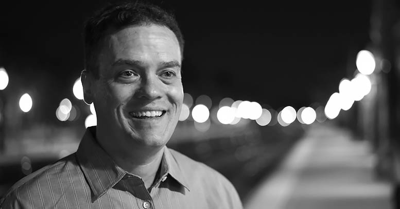 Steve Kostal in front of railroad tracks.